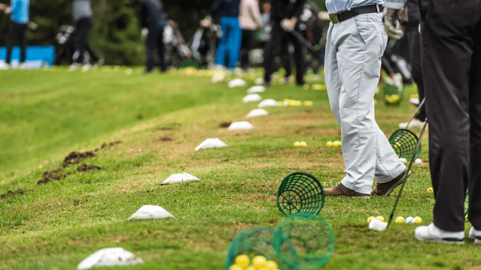 Golfers hitting balls on a practice range