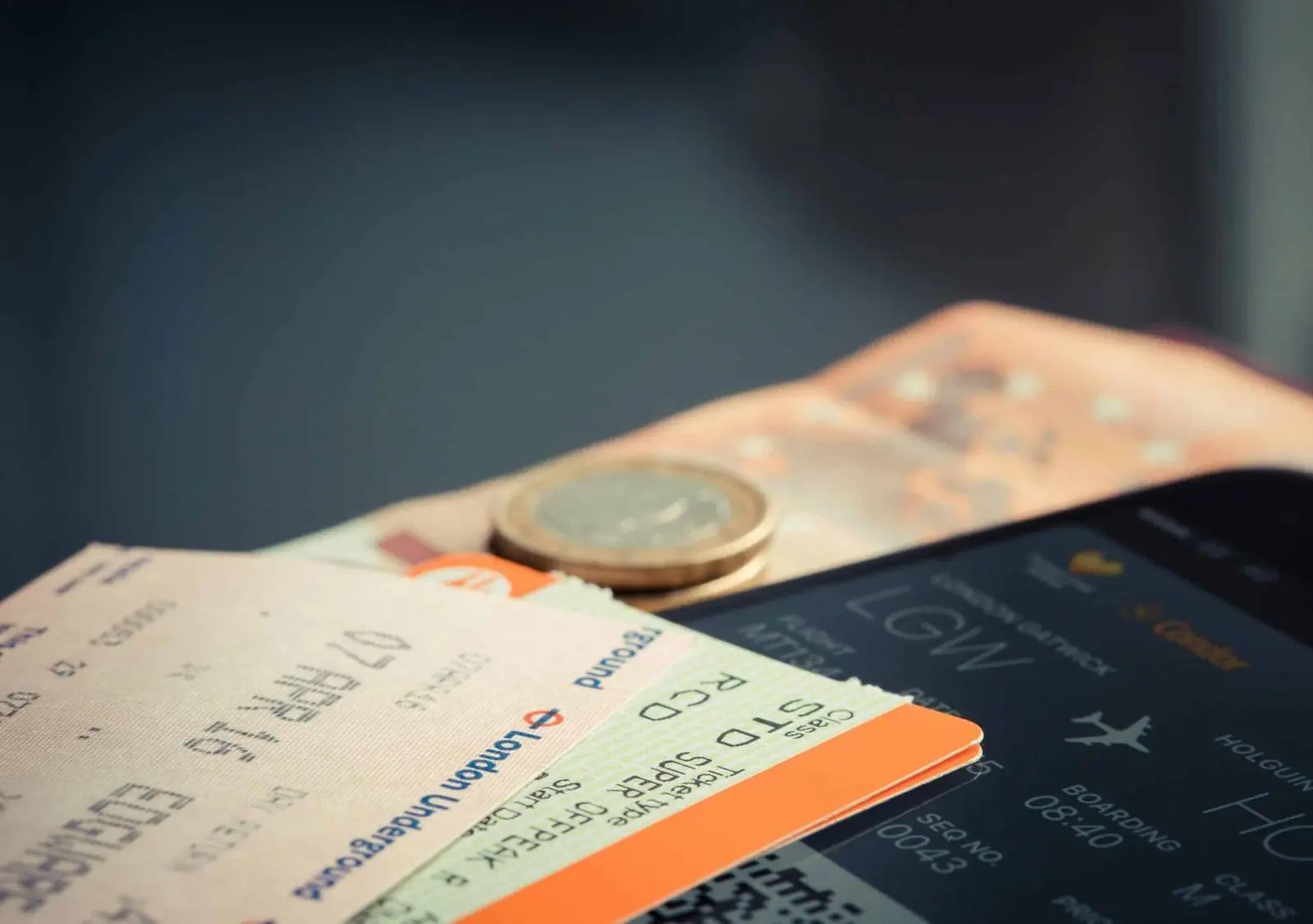Boarding passes and a coin on a passport