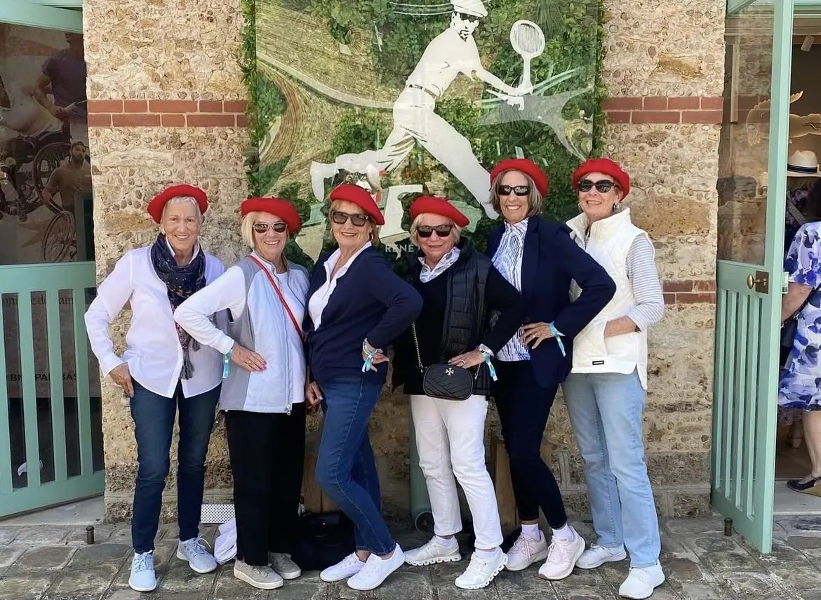 A team posing with red hats
