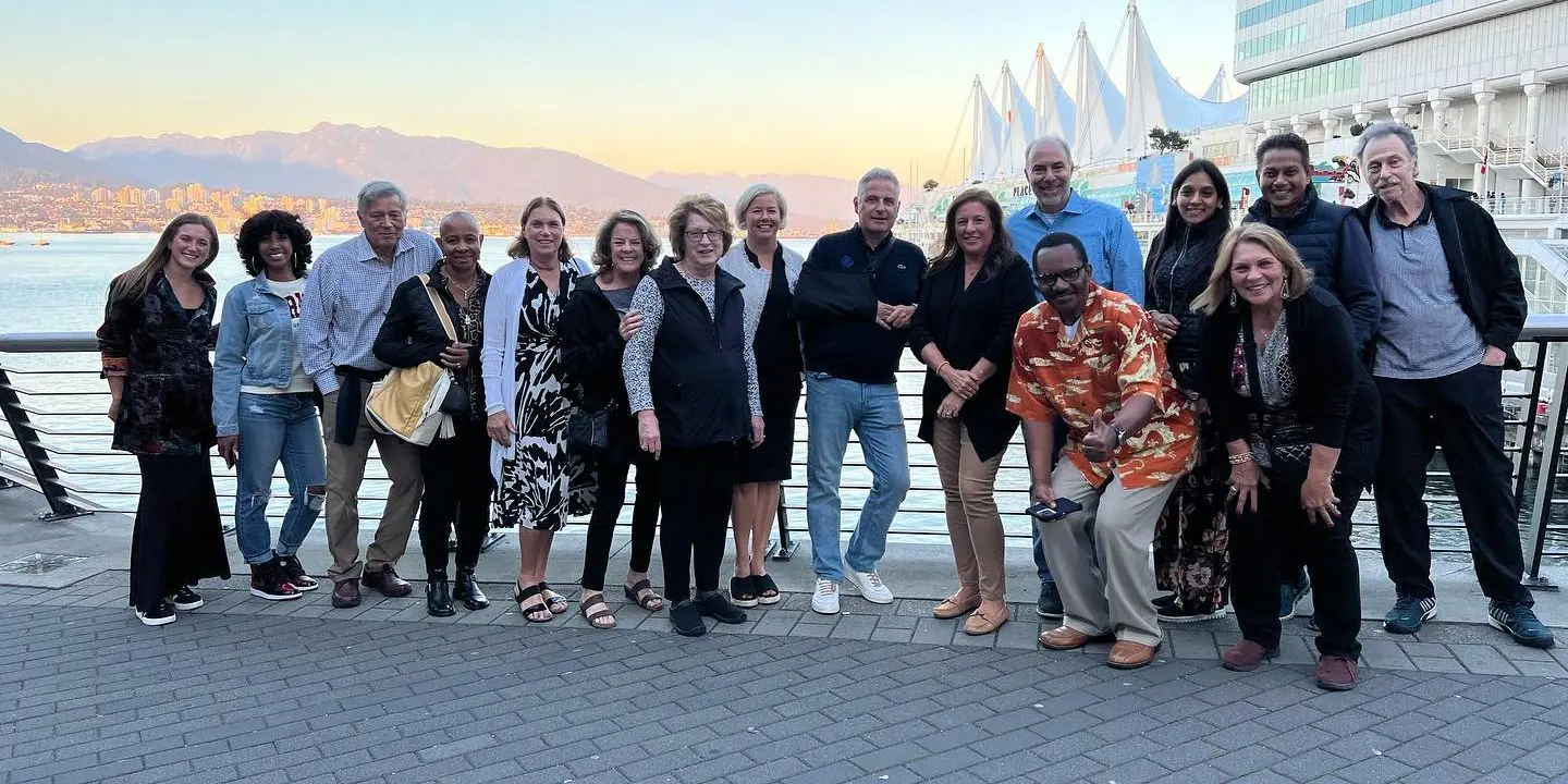 MAC Sports Travel group on the Vancouver waterfront at sunset
