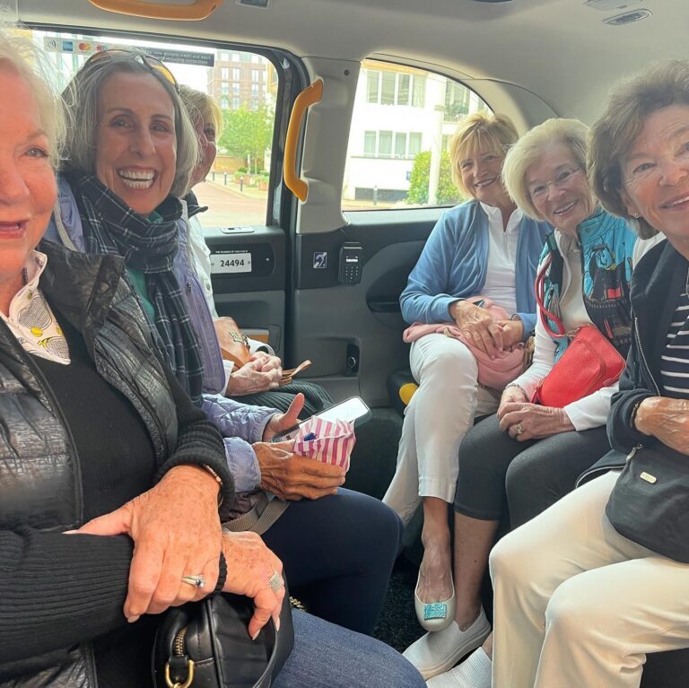 MAC Sports Travel guests laughing together in a London taxi on their Wimbledon trip